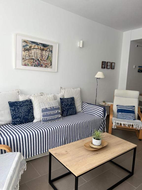 a living room with a couch and a table at Fantastic apartment a few meters from the beach in the center of Estartit in L'Estartit