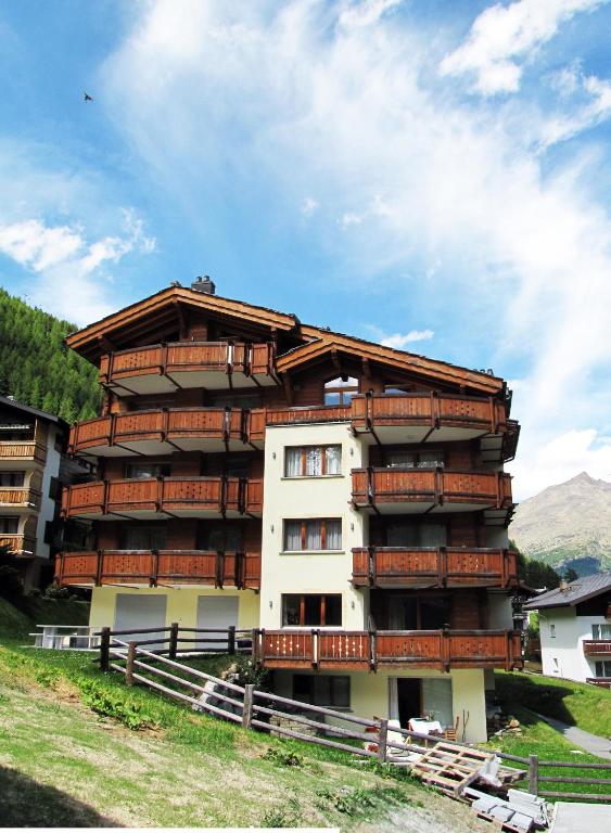 a large apartment building with a wooden roof at Aramis in Saas-Fee