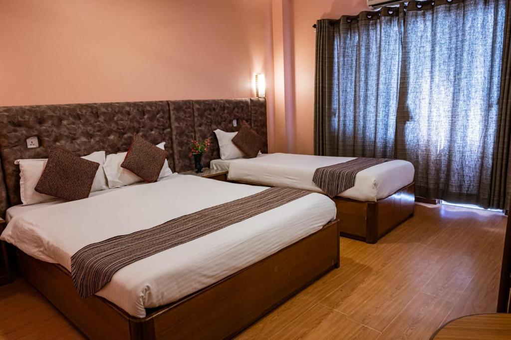 Postel nebo postele na pokoji v ubytování Kathmandu Prince Hotel