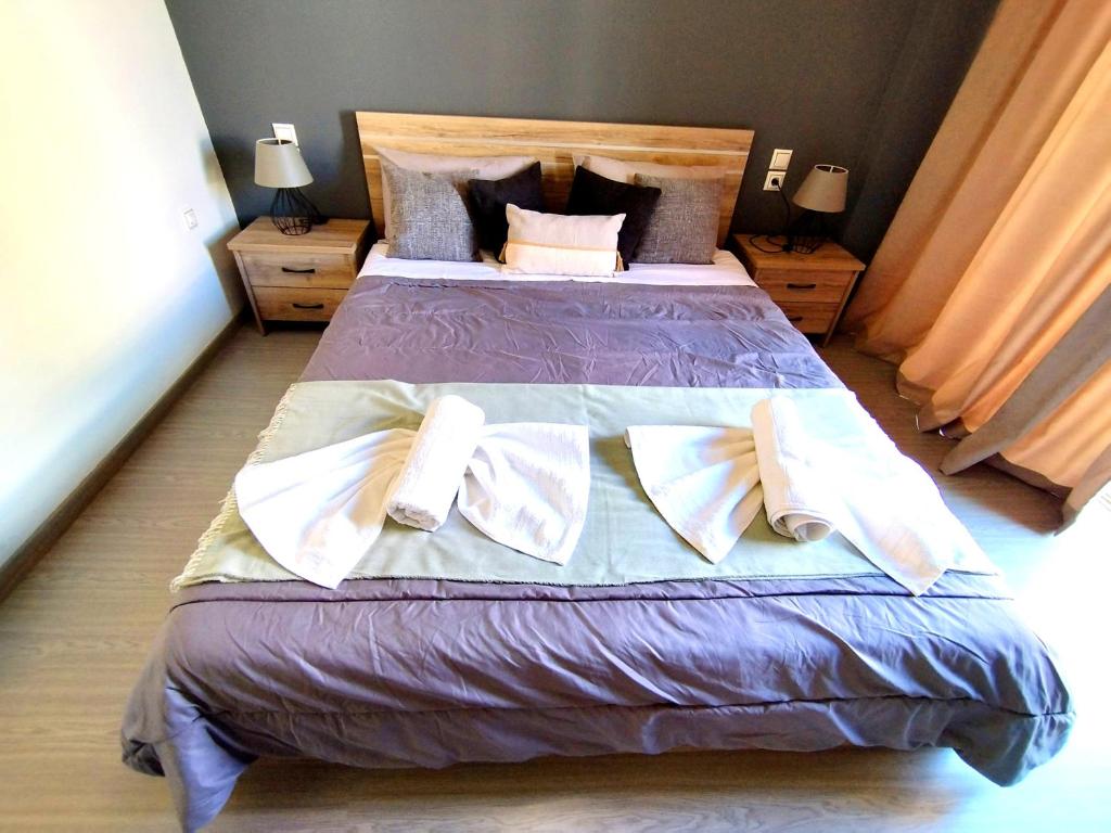 a bedroom with a large bed with two pillows at Sophie's Guest House in Volos