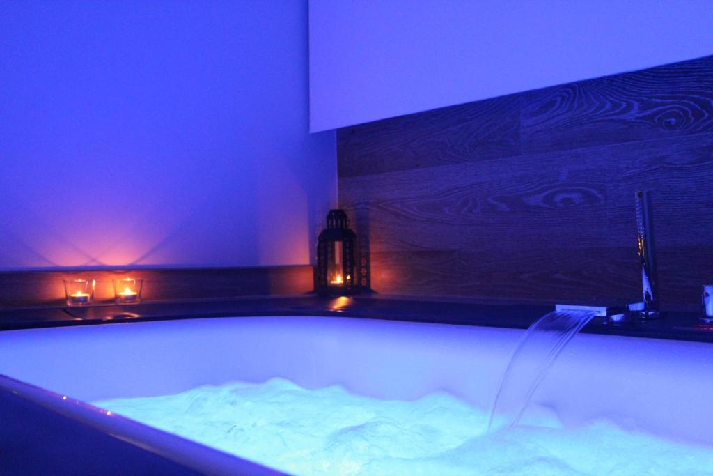 a bath tub in a room with blue lights at Le casette in Monopoli