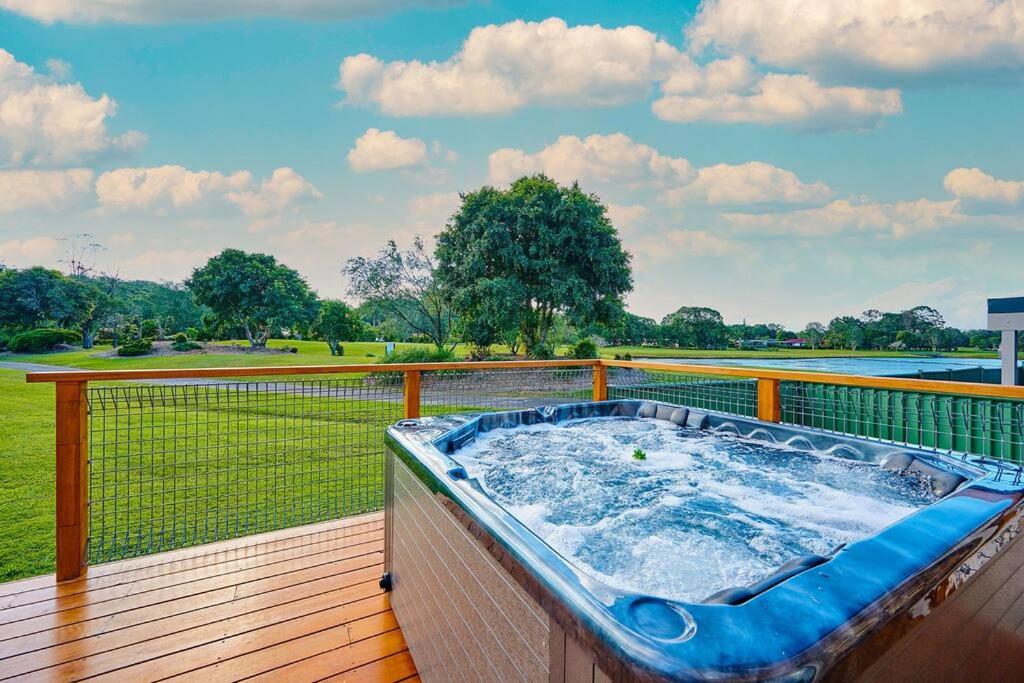 a hot tub on a deck with a view of a field at A kids dream & paradise for parents in Ocean Shores