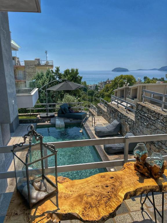 a house with a swimming pool with a view of the ocean at Villa Thalia in Kavala