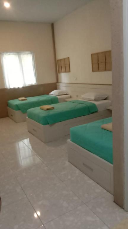 Postel nebo postele na pokoji v ubytování Jawa Jiwa G-Land Resort
