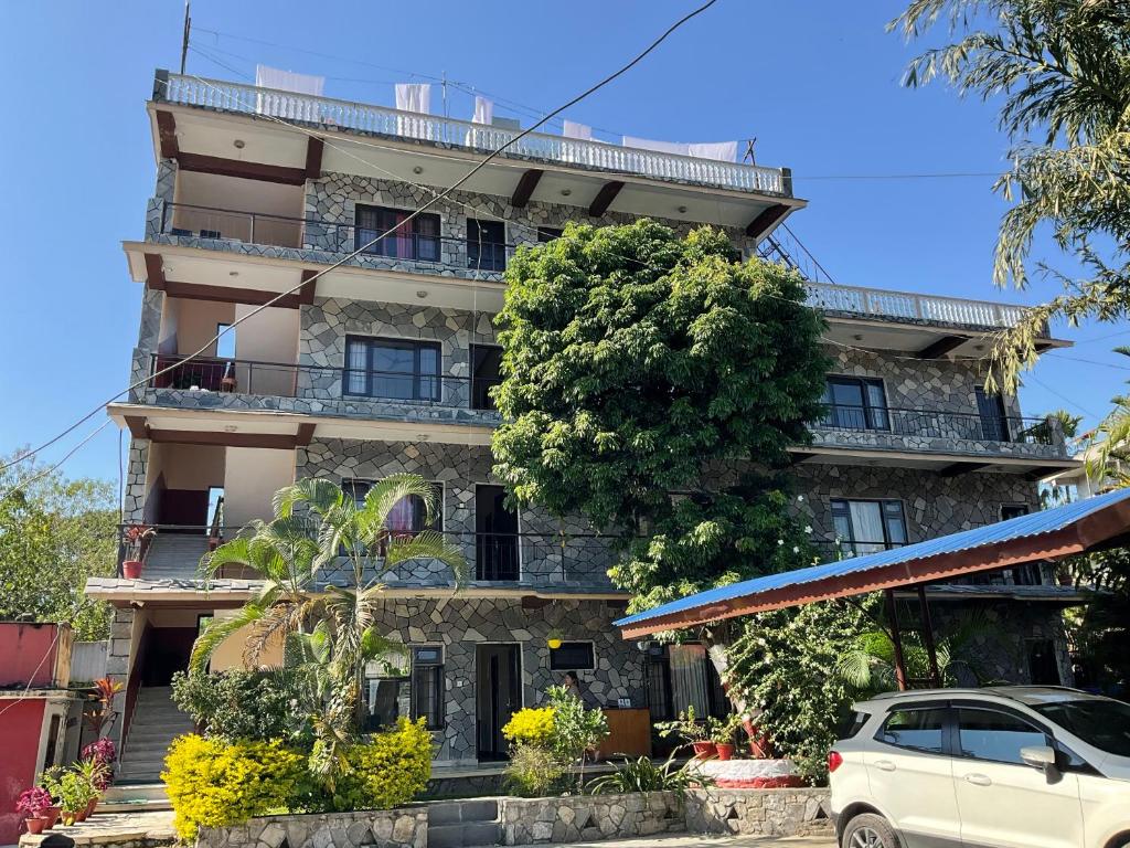 a building with a car parked in front of it at Trekkers Lodge in Pokhara