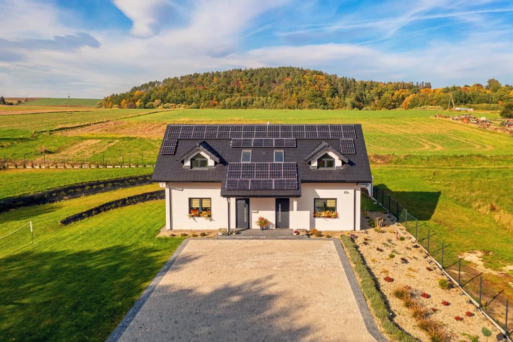 a house with a lot of solar panels on it at Domek na wsi in Polanica-Zdrój