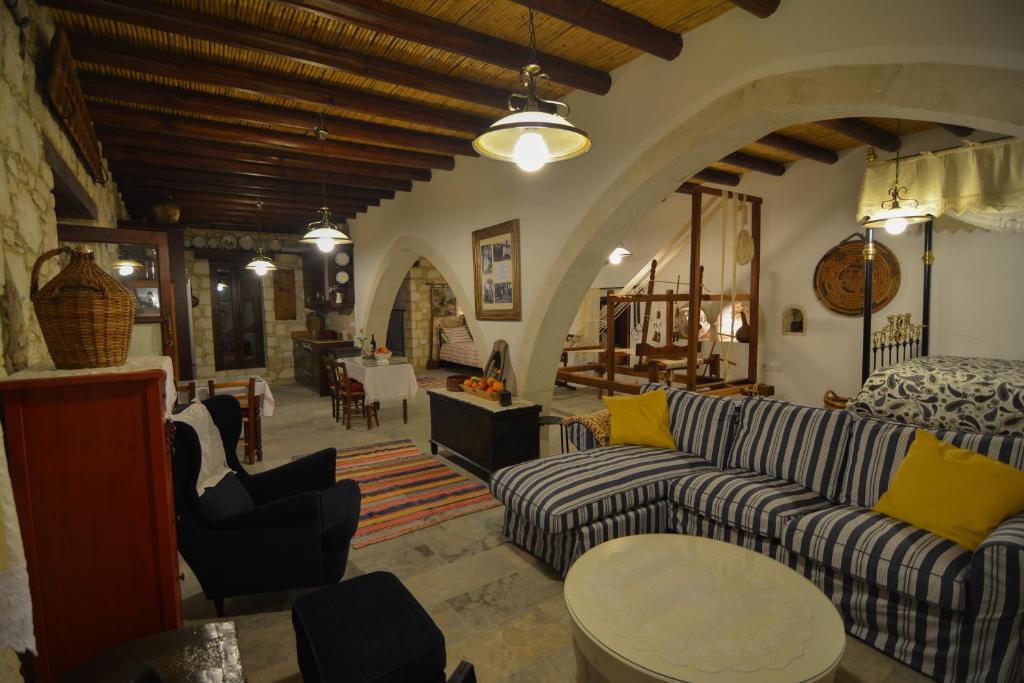 a living room with a couch and a table at Aliki's House 1+ 2 in Polis Chrysochous