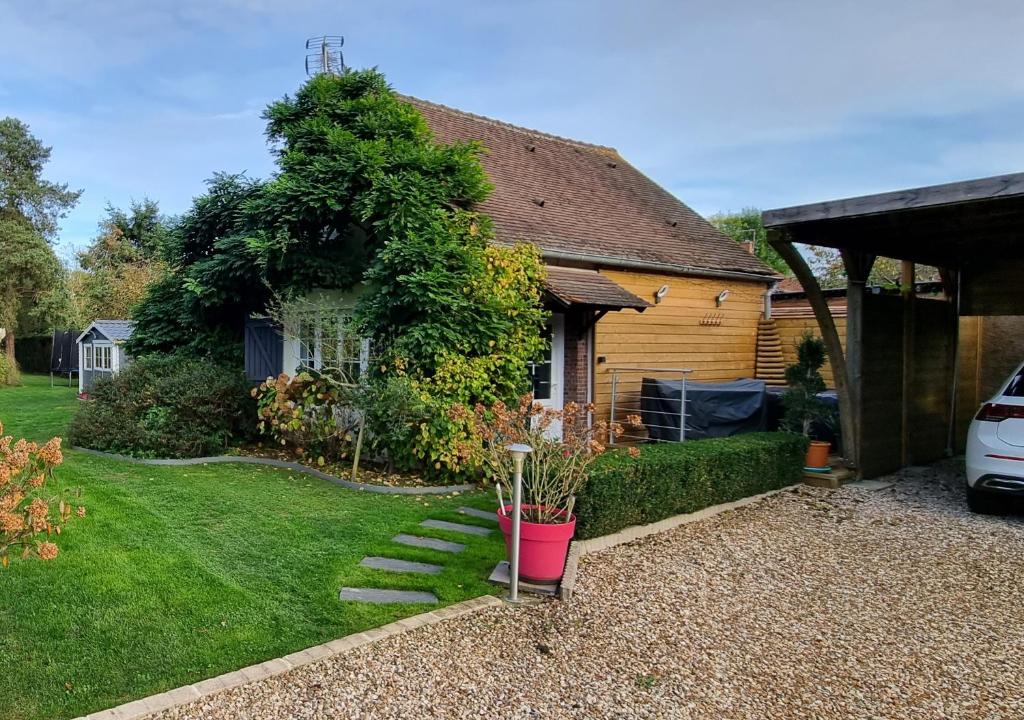 a house with a plant in a yard at La Berceuse Normande in Dampierre-sur-Avre