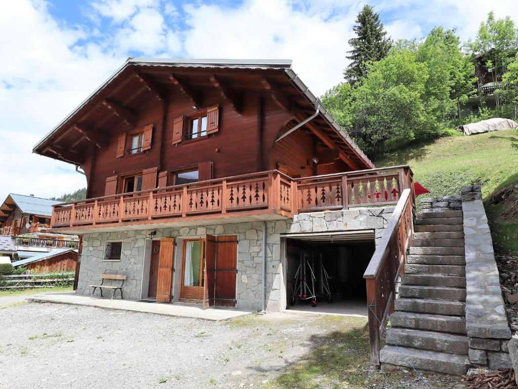 a large wooden house with a balcony and stairs at Chalet Arêches-Beaufort, 9 pièces, 10 personnes - FR-1-342-232 in Beaufort