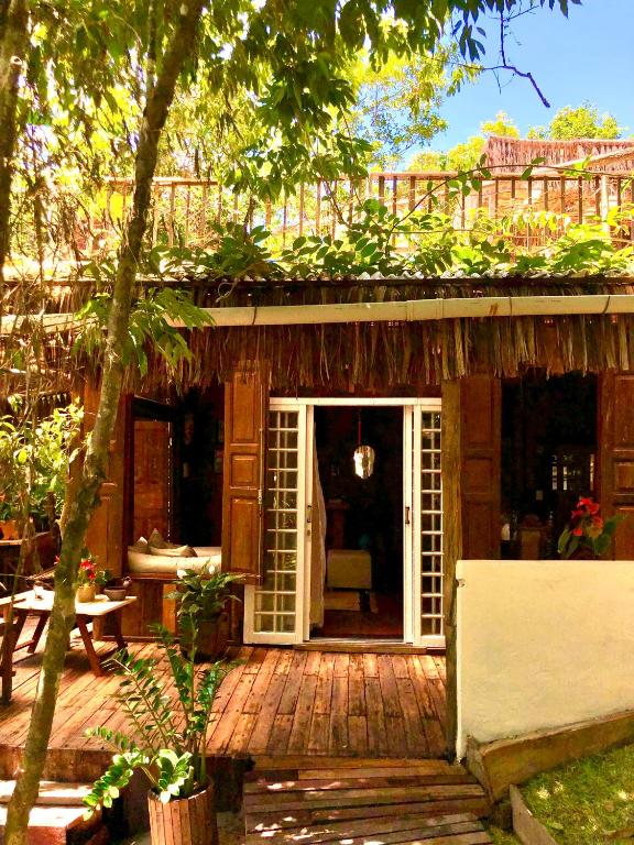a house with a porch with a door open at Bangalô Maria, luxo próximo ao mar in Trancoso