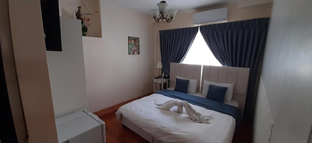 Postel nebo postele na pokoji v ubytování The Boutique Hotel Amman
