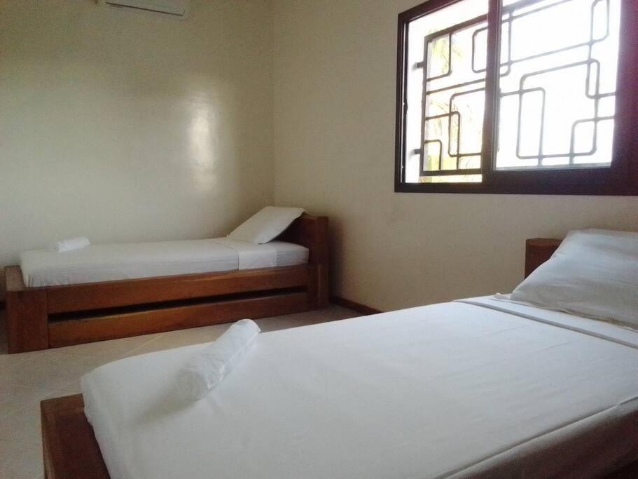 Ein Bett oder Betten in einem Zimmer der Unterkunft BEL HORIZON Nosy Be