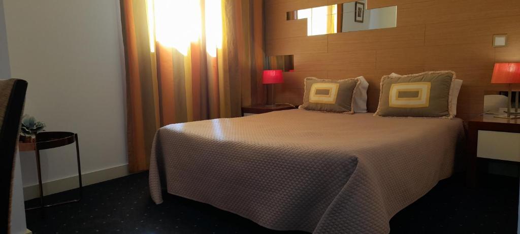 Postel nebo postele na pokoji v ubytování Hotel Abade João