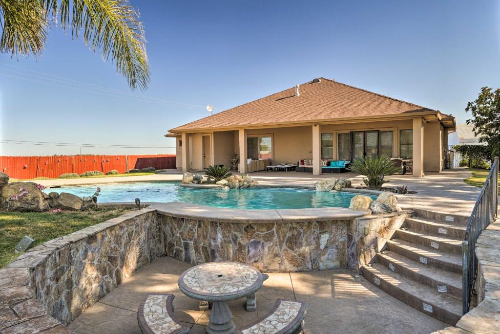a house with a swimming pool in front of a house at Near Wineries Elk Grove Getaway with Saltwater Pool in Elk Grove