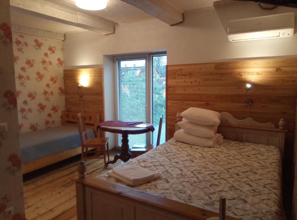 a bedroom with a bed and a table and a window at TäheMaja5 in Viljandi