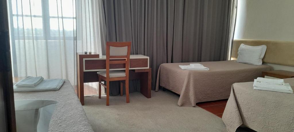 Postel nebo postele na pokoji v ubytování Hotel Abade João