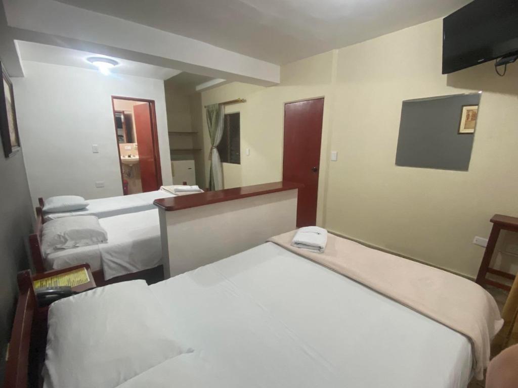 Postel nebo postele na pokoji v ubytování Hotel Caldas Plaza