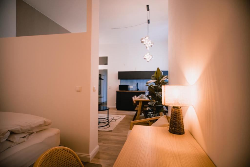 a living room with a lamp on a table at The Weinert Suites in Berlin