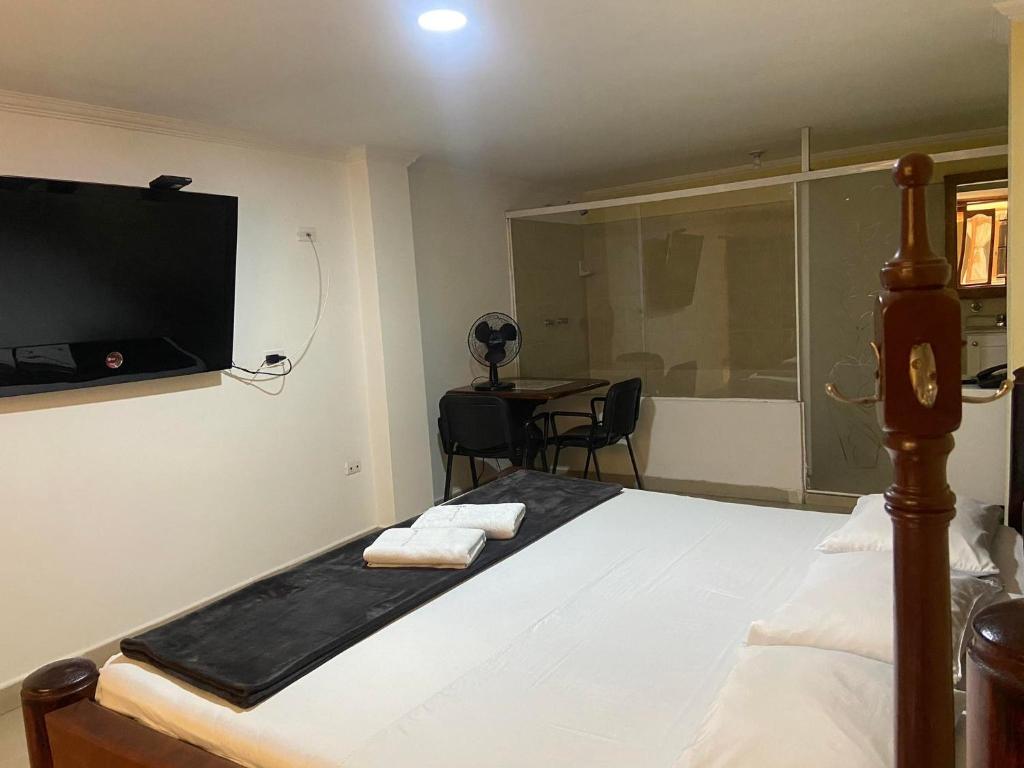 Postel nebo postele na pokoji v ubytování Hotel Caldas Plaza