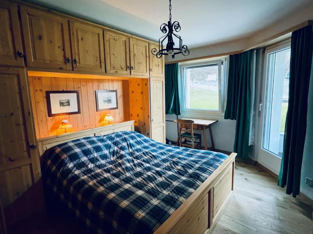 a bedroom with a bed with a plaid blanket at Sankt Moritz Chesa Ruinatsch 50 in St. Moritz