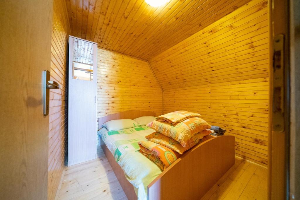 a bedroom with a bed in a wooden room at Apartment Dobre Vode in Žabljak