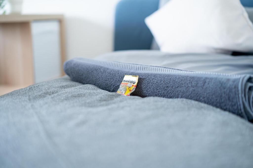 a close up of a blue blanket on a bed at FULL HOUSE Studios - R85 Apartments in Zwickau