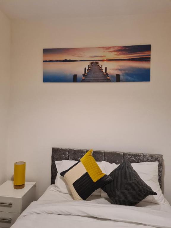 a bedroom with a bed with a painting on the wall at TimeChance Property Homz - Norton Road 1 Bed Apartment in Stockton-on-Tees