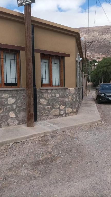 a house with a car parked in front of it at La Carmela, Tilcara in Tilcara