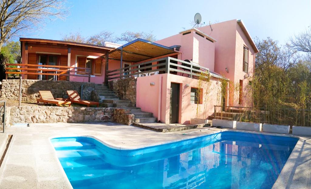 a house with a swimming pool in front of a house at Mendiolaza valle del sol in Mendiolaza