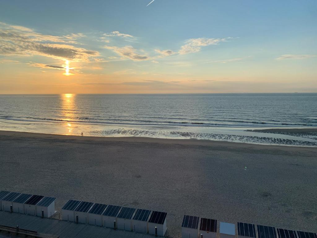 an aerial view of the beach at sunset at Wonderful architect designed flat with sea view in Ostend