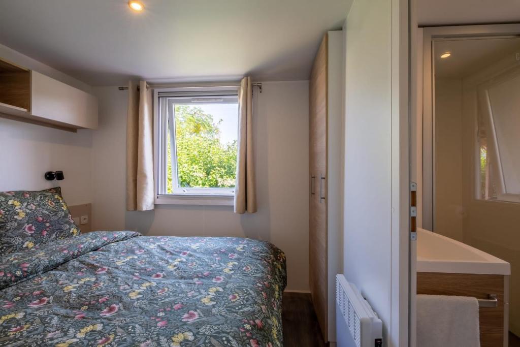 une petite chambre avec un lit et une fenêtre dans l'établissement Little John, à Fréjus 39 autres photos