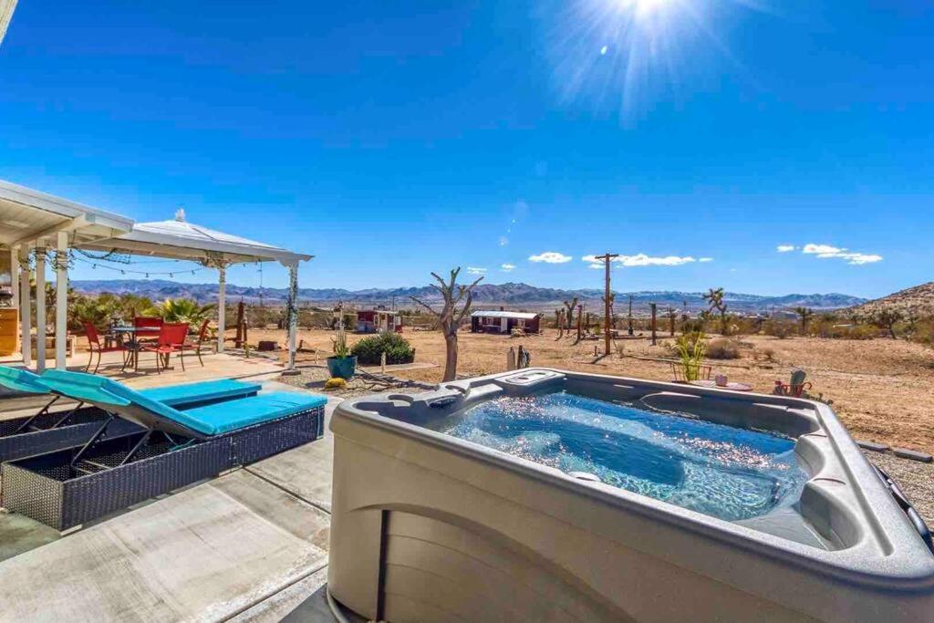 a hot tub on a patio with a view of the desert at Desert Dreamer in Yucca Valley