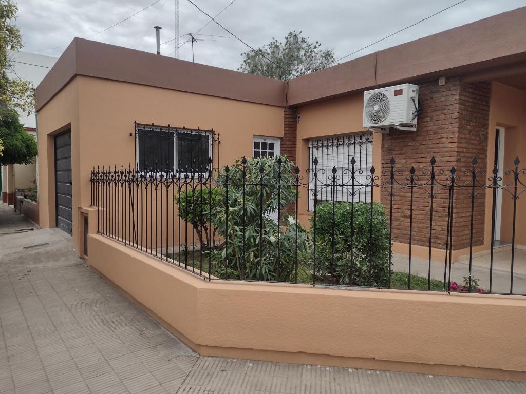 a building with a fence and a fan at Casa en Santa Rosa in Santa Rosa