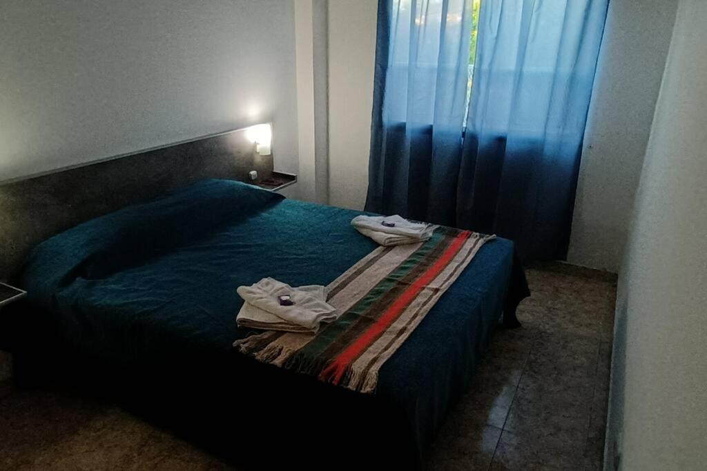 um quarto com uma cama com duas toalhas em América 1 em Villa Luzuriaga