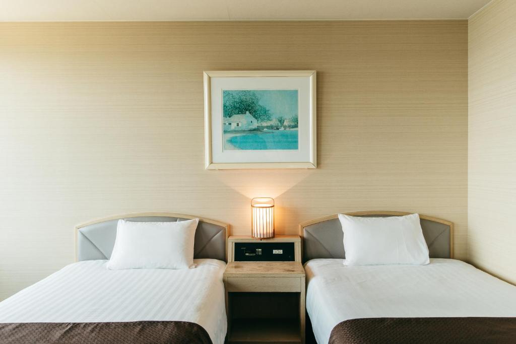 Postel nebo postele na pokoji v ubytování KAMENOI HOTEL Setouchi Hikari
