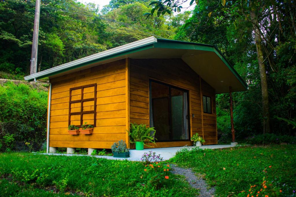 a small wooden cabin with a pitched roof at Cabañas Lys in Monteverde Costa Rica