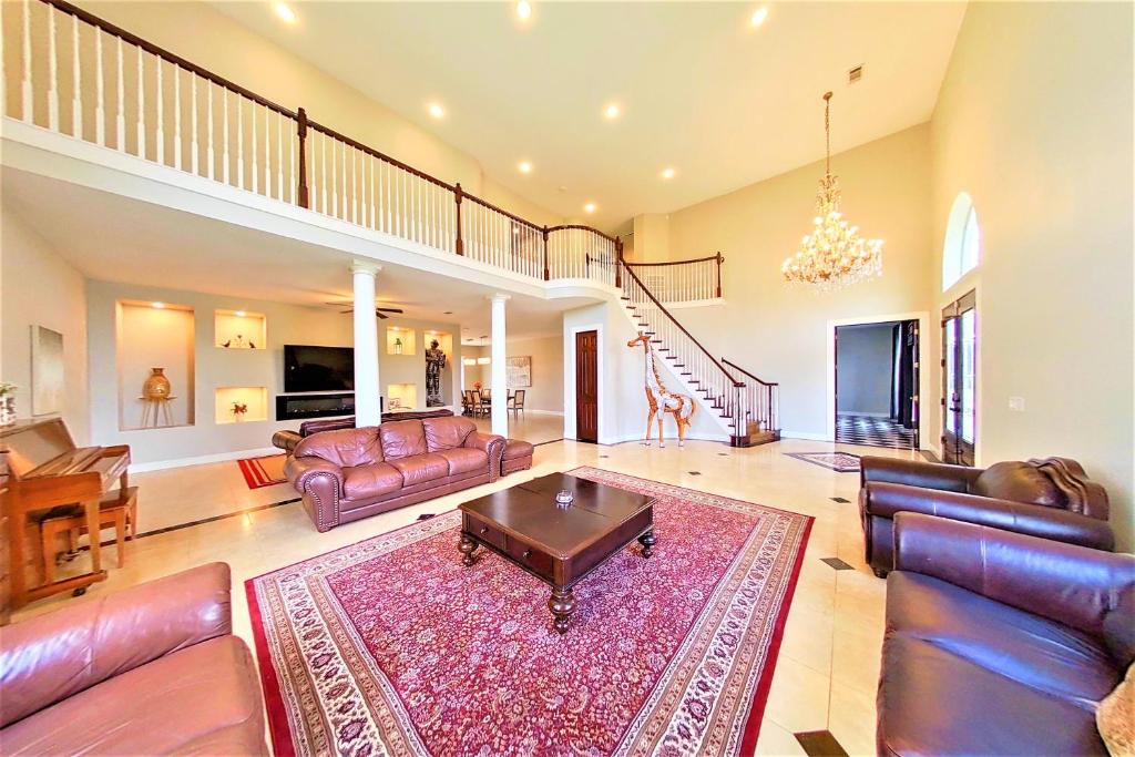 a large living room with leather furniture and a rug at Lions Meadow in Dickinson