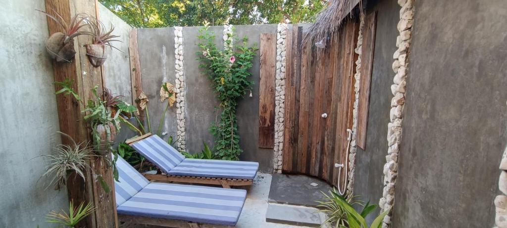 a pair of blue chairs sitting on a patio at Ras Village in Rasdhoo