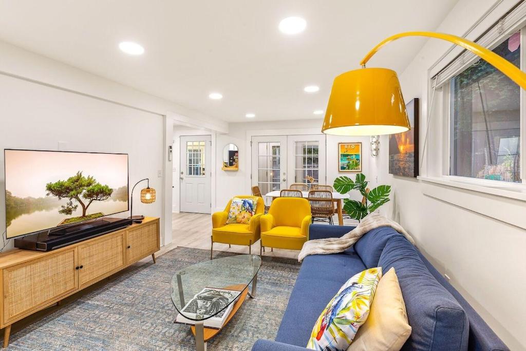 a living room with a blue couch and yellow chairs at NEW: Bright, Peaceful Retreat in Iconic Seattle Neighborhood in Seattle