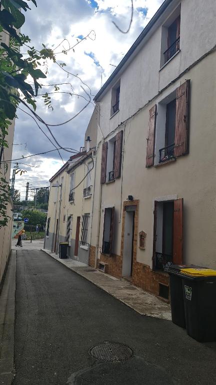eine leere Straße neben einem weißen Gebäude in der Unterkunft SAINT DENIS PARIS STADE de FRANCE DISNEY in Saint-Denis