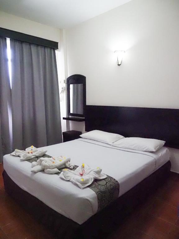 Postel nebo postele na pokoji v ubytování Glory Beach Resort