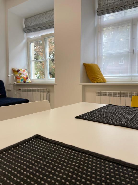 a room with a white table with a black rug at Oldtown apartment in Vilnius