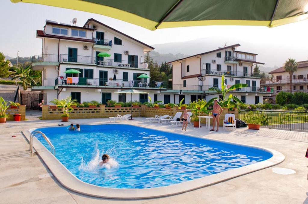 a person in a swimming pool in a hotel at Appartamenti Pirrera in Patti