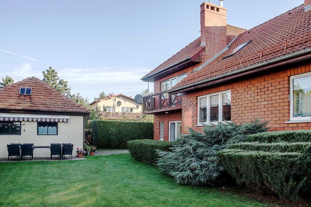 a home with a yard with chairs and a house at Willa Janina in Jelenia Góra