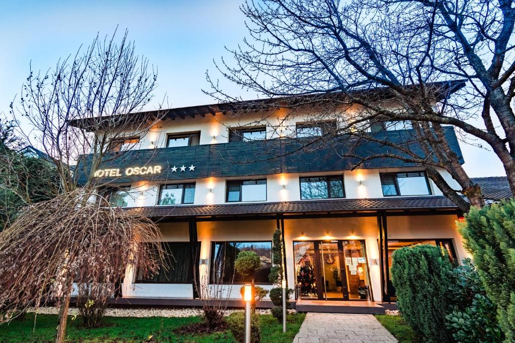 a building with a sign on the front of it at Hotel Oscar in Câmpina