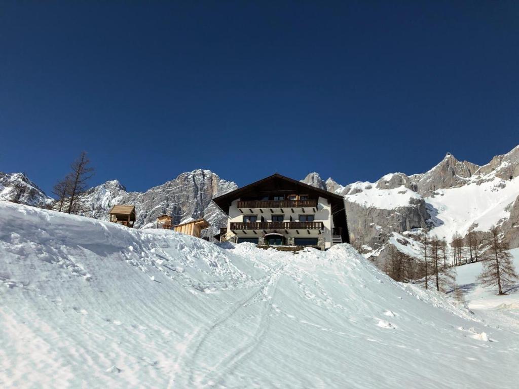 a ski lodge in the mountains with snow at Berghotel Türlwand in Ramsau am Dachstein