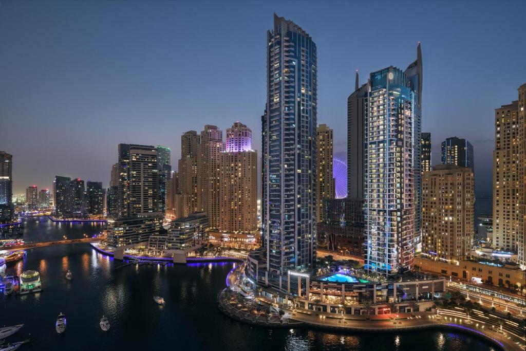 a view of a city skyline at night at InterContinental Dubai Marina by IHG in Dubai