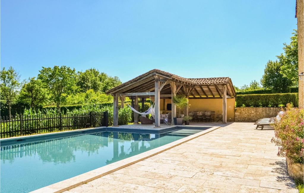 a pool with a gazebo next to a house at Beautiful Home In Fleurac With 3 Bedrooms, Private Swimming Pool And Outdoor Swimming Pool in Fleurac
