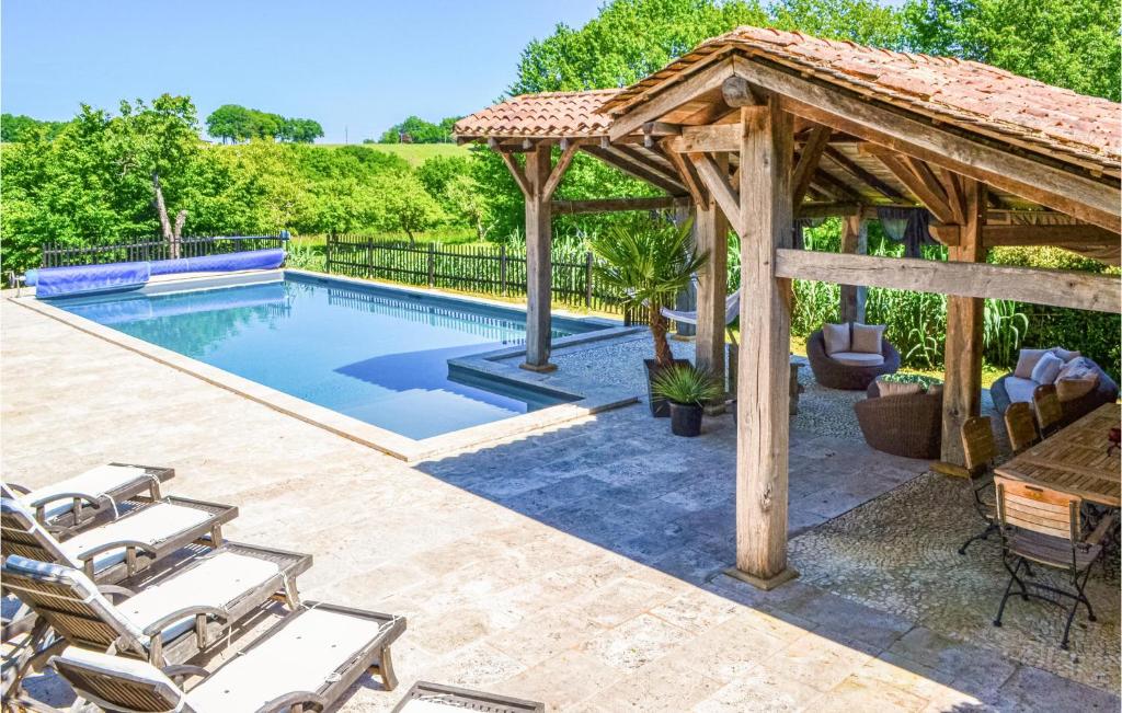 a pool with a gazebo and chairs around it at Beautiful Home In Fleurac With 3 Bedrooms, Private Swimming Pool And Outdoor Swimming Pool in Fleurac
