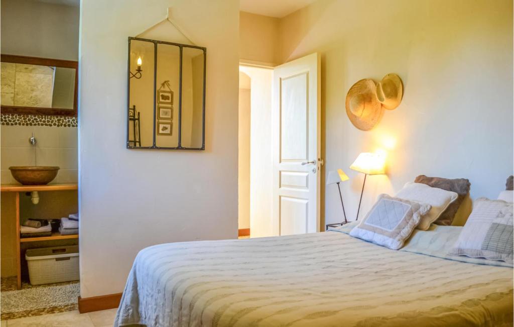a bedroom with a bed and a mirror on the wall at Beautiful Home In Fleurac With 3 Bedrooms, Private Swimming Pool And Outdoor Swimming Pool in Fleurac